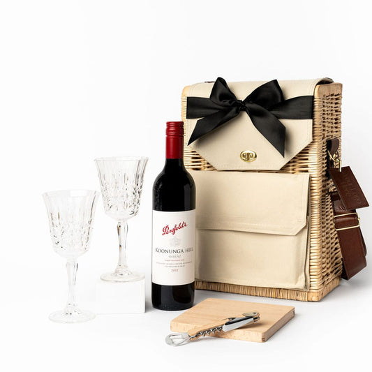 Picnic On The Go gift hamper. A Portable Wicker Picnic Basket with Penfolds Koonunga Hill Shiraz, acrylic etched wine glasses, beech wooden serving board and bottle opener. 