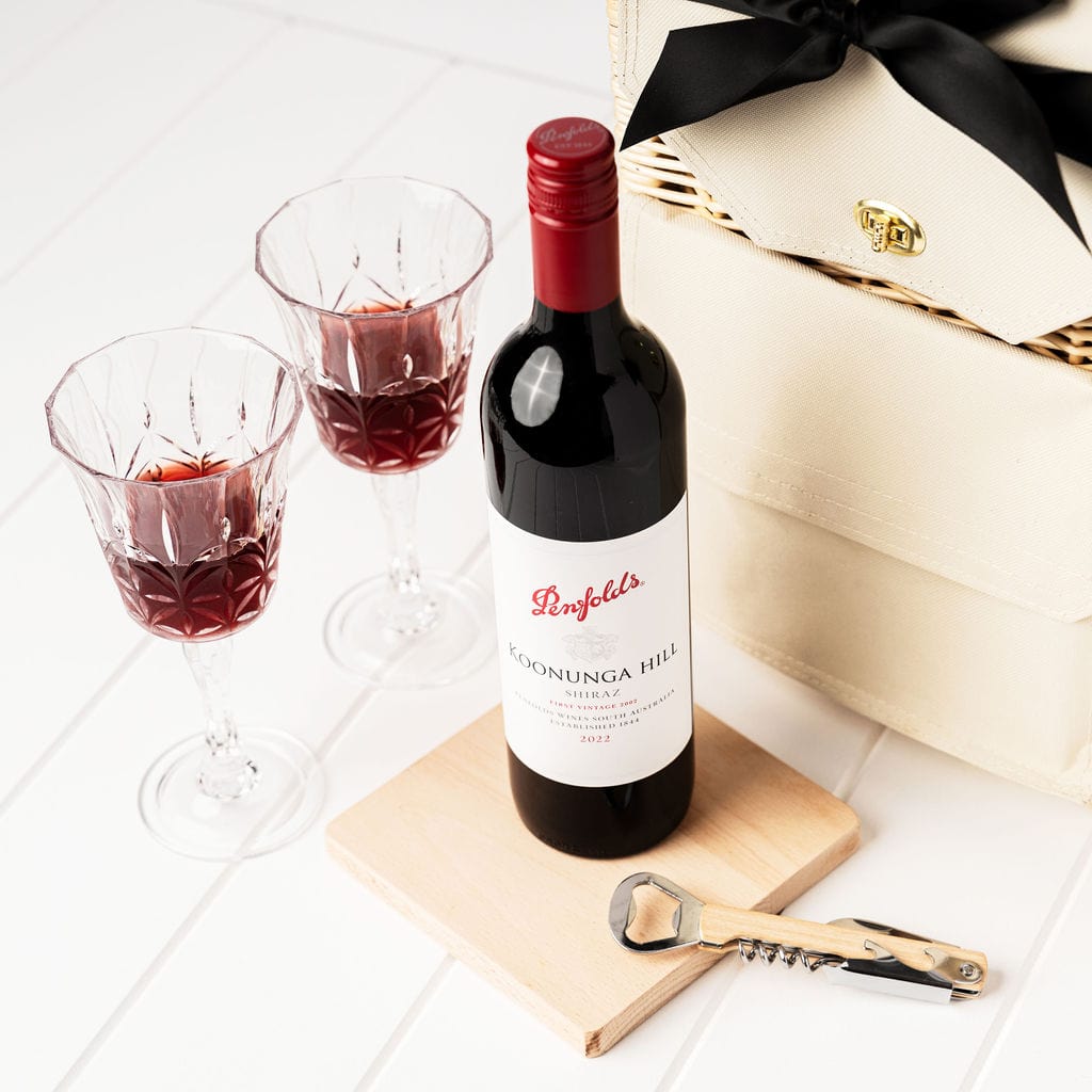 Picnic On The Go gift hamper. A Portable Wicker Picnic Basket with Penfolds Koonunga Hill Shiraz, acrylic etched wine glasses, beech wooden serving board and bottle opener.