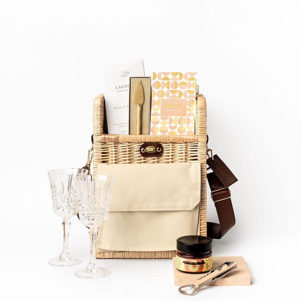 The Deluxe Day Out Portable Wicker Basket Gift Hamper. Filled with G FOR GEORGE Red Capsicum & Basil Tapenade 110g, MOREISH MENU Gourmet Lavosh Crackers Assorted - 100g, GRAZE Gourmet Bites - Zesty Chilli & Lime Thai Cashews 75g, ACRYLIC Etched Wine Glass BPA Free - 295ml, ACRYLIC Etched Wine Glass BPA Free - 295ml, SERVED 1pc Cheese Knife - Brass Gold.