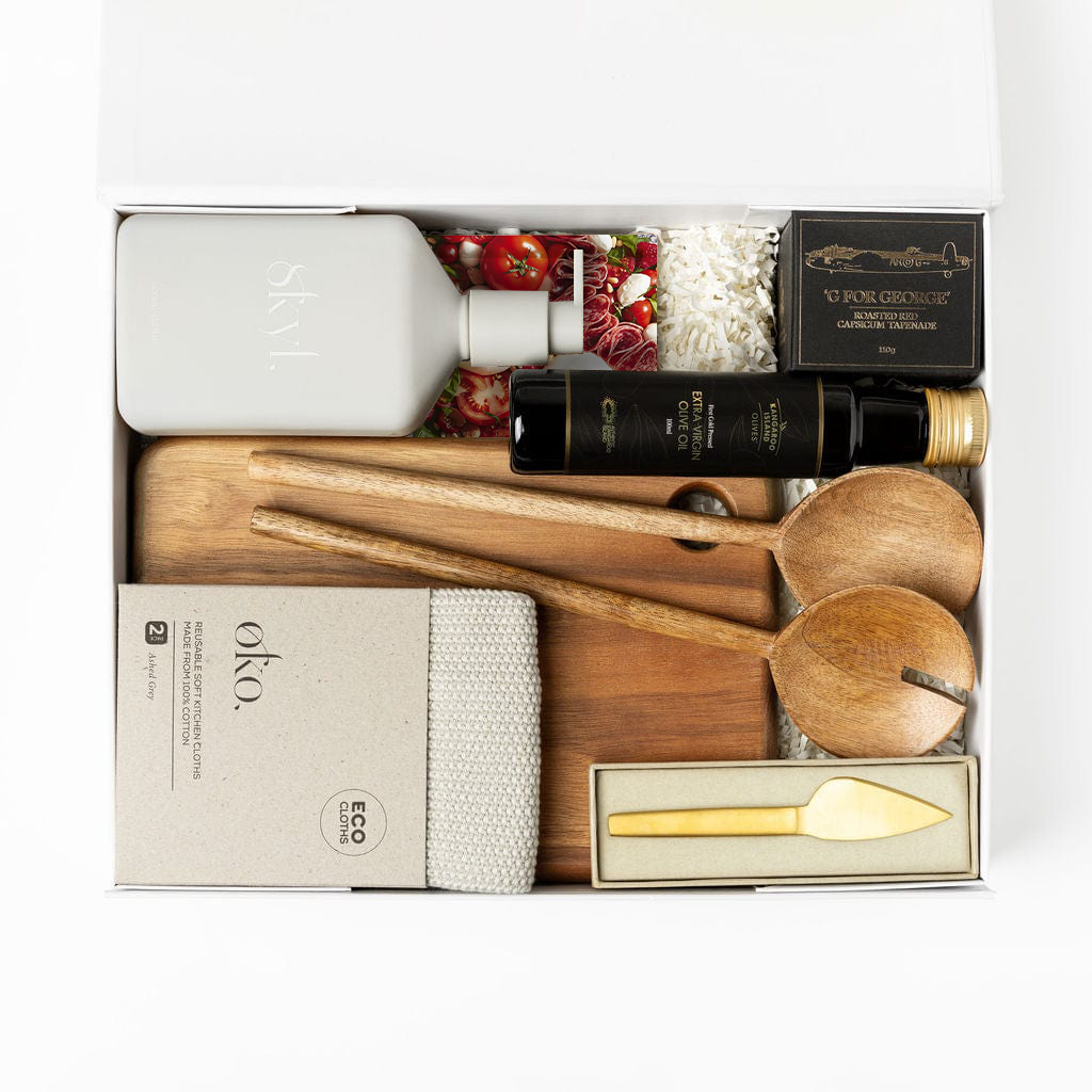 Ellar Boutique Settlement Gift Happy At Home with gourmet book, salad servers, capsicum tepenade, gold cheese knife, luxury hand wash, cotton kitchen cloth, wooden board and premium olive oil.