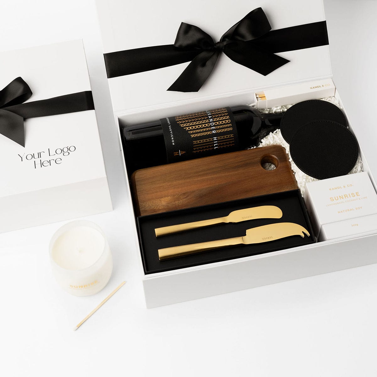 Settlement Gift with wine, acacia wooden board, cheese knives, coasters and a candle. 