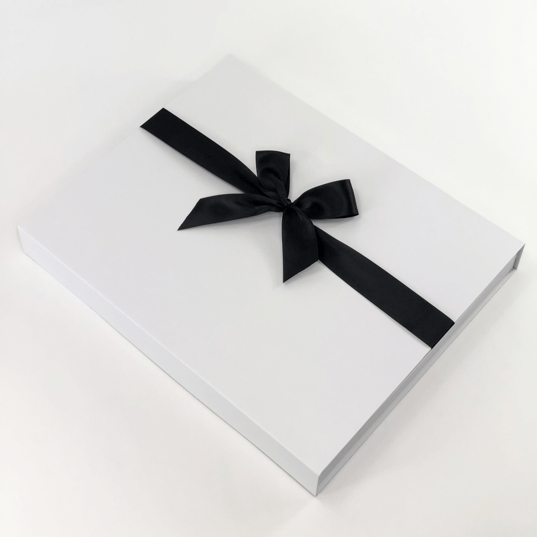 white gift box with black ribbon
